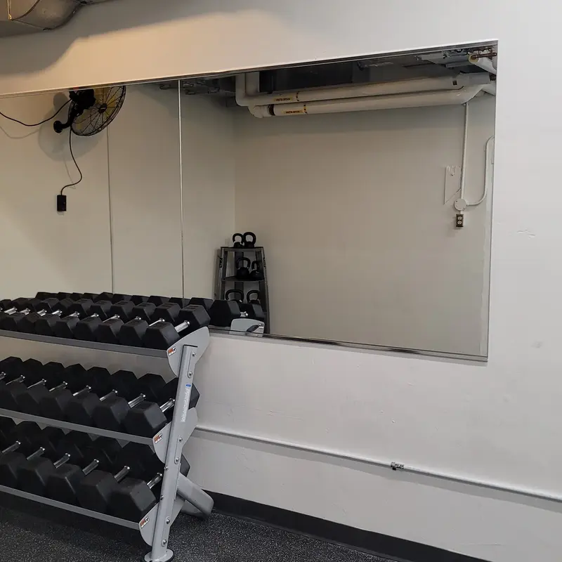 Installation of mirror at a gym.