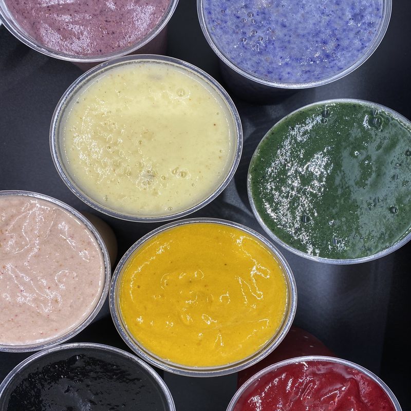 Various juice shots of various colors.