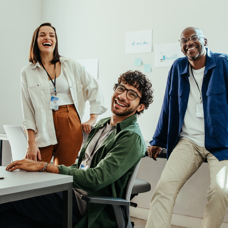 Drei Kollegen lachen im Büro