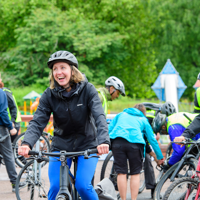 Our CEO Sarah Mitchell getting out and about with the The Big Bike Revival in Wolverhamtpon

(Picture of Sarah smiling whilst riding a bicycle, with several people having their bikes serviced in the background)