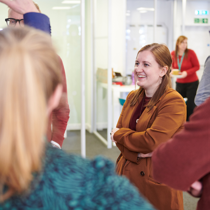 Employees congregating and smiling