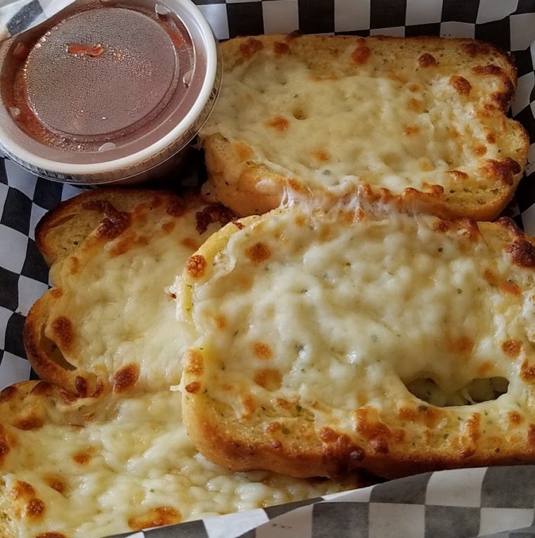 Start dinner off with an appetizer like this garlic bread with cheese, served with our house red sauce.