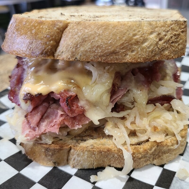 A Reuben sandwich on marbled rye bread.