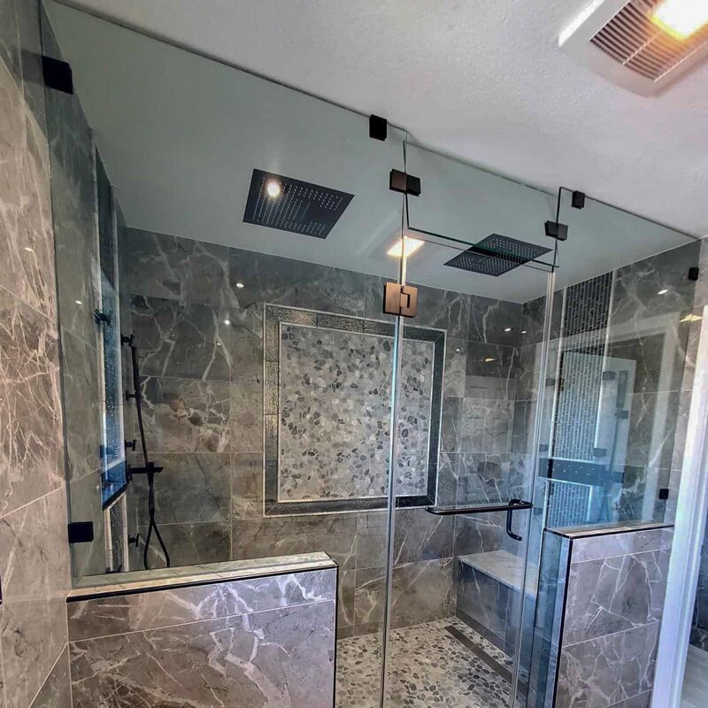 Top to bottom tempered glass for a shower enclosure with protective coating