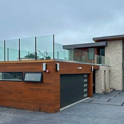 Residential project with glass railings and tall glass entrance