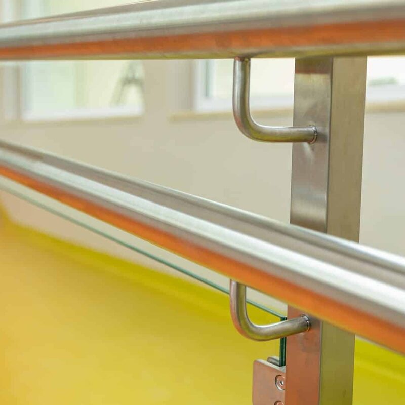 Glass railing with custom  holes and silver Hardware