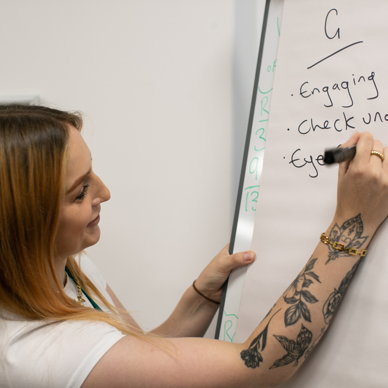 Employee taking notes on the whiteboard