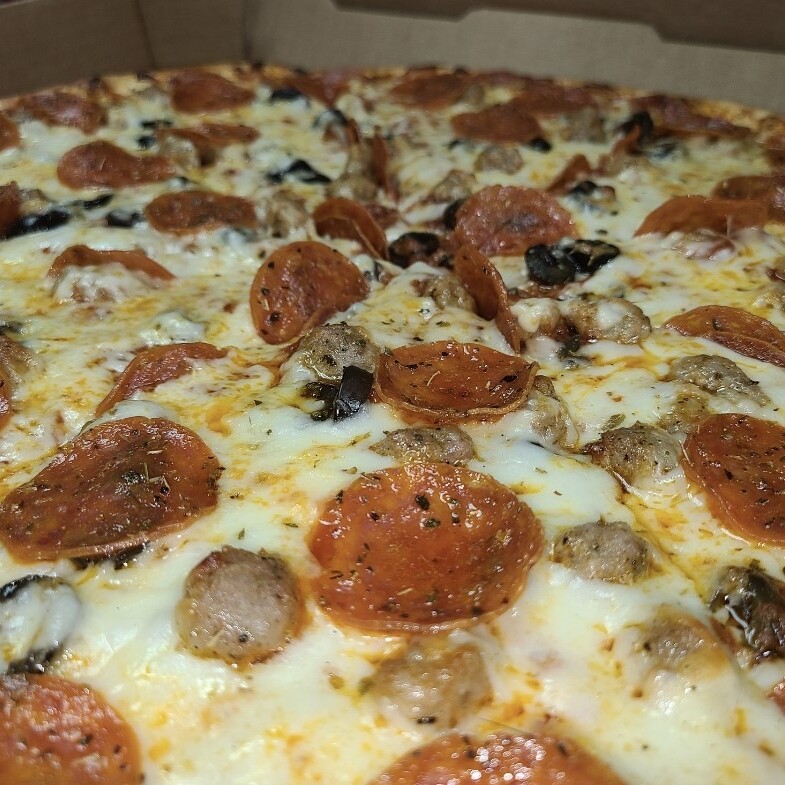 Close up show of a delicious combo pizza